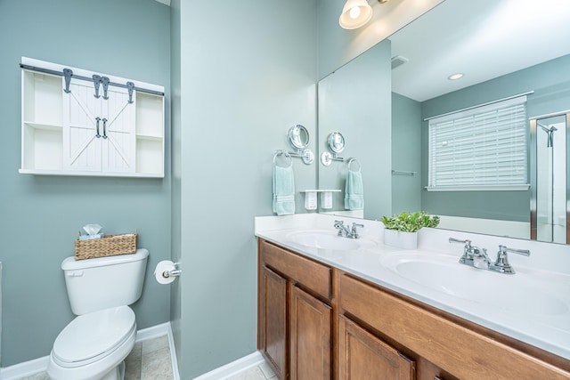 bathroom with tile patterned floors, double vanity, toilet, and a sink