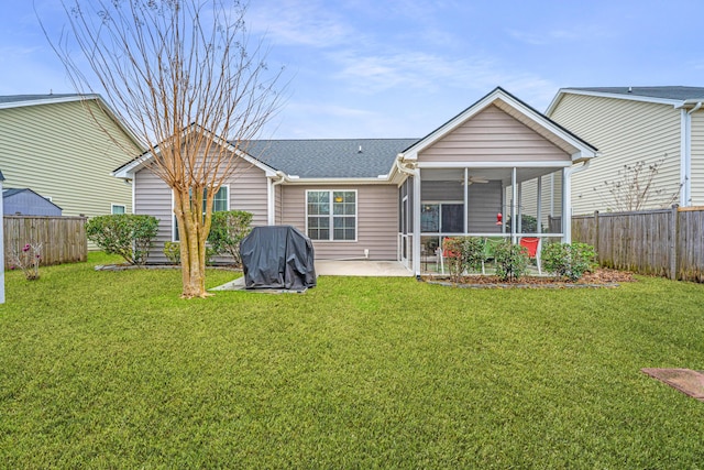 back of property with a patio area, a yard, a fenced backyard, and a sunroom