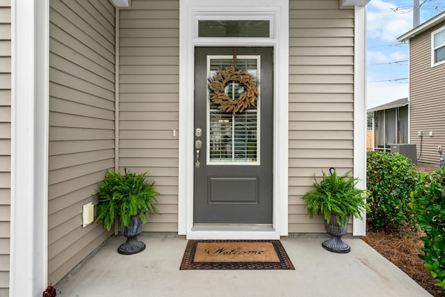 view of exterior entry featuring central AC unit