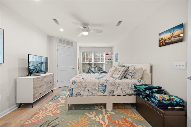 bedroom with ceiling fan and light hardwood / wood-style floors