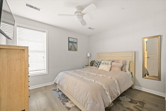 bedroom with ceiling fan and hardwood / wood-style flooring