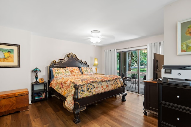 bedroom featuring access to exterior, hardwood / wood-style floors, and ceiling fan