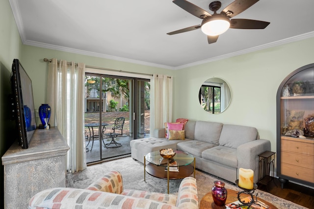 living room with hardwood / wood-style flooring, ceiling fan, and ornamental molding