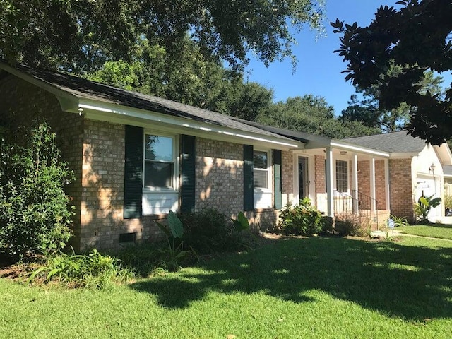 single story home featuring a front yard, brick siding, a porch, a garage, and crawl space