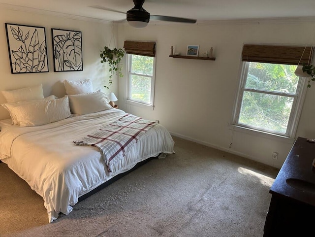 bedroom featuring ceiling fan, baseboards, carpet floors, and ornamental molding