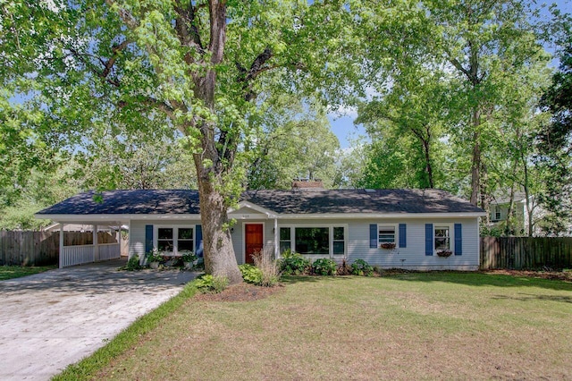 ranch-style house featuring a chimney, fence, concrete driveway, a carport, and a front yard