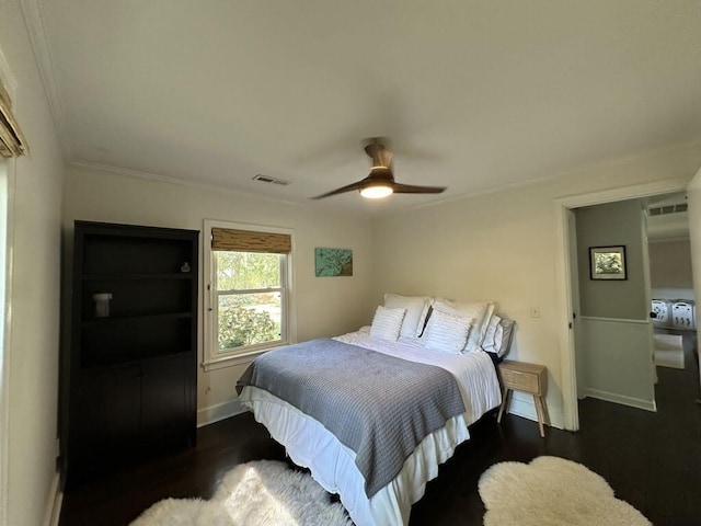 bedroom featuring visible vents, wood finished floors, baseboards, and ceiling fan