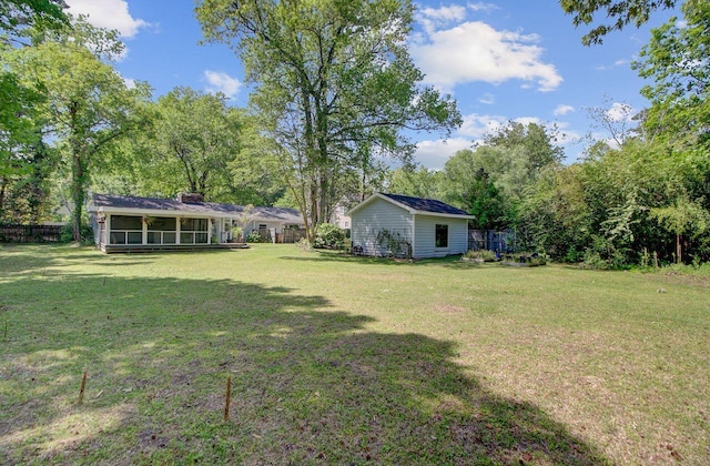 view of yard with a sunroom and fence