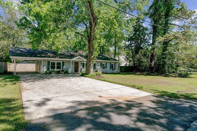 single story home featuring fence, a front lawn, driveway, and an attached carport