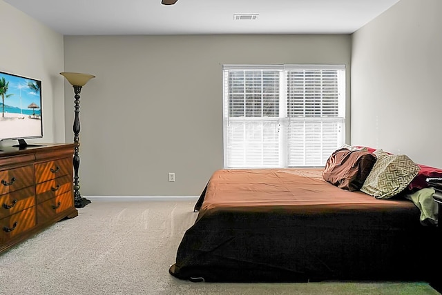 carpeted bedroom with visible vents and baseboards