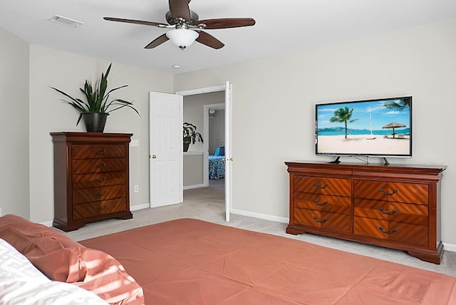 bedroom with baseboards, a ceiling fan, visible vents, and light colored carpet