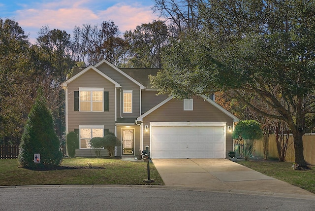 view of front facade featuring a garage and a lawn