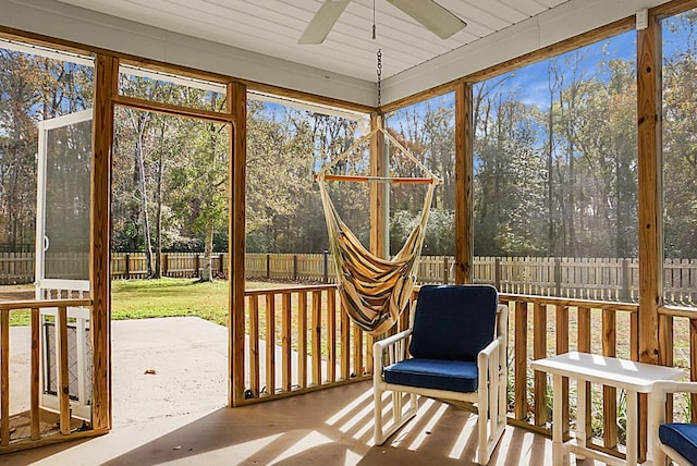 unfurnished sunroom with ceiling fan