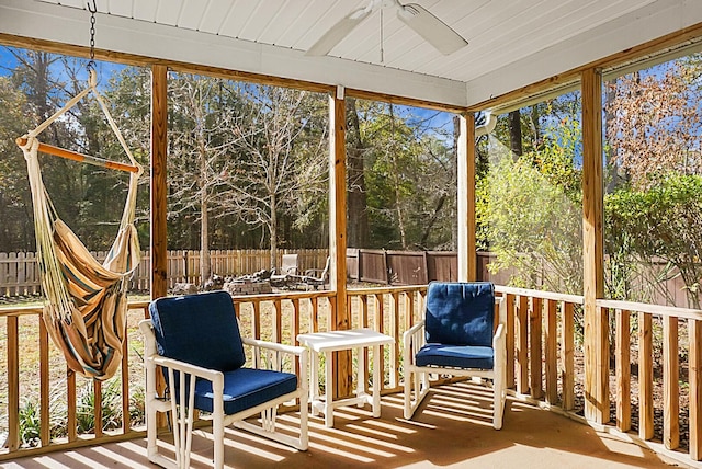 unfurnished sunroom with a ceiling fan