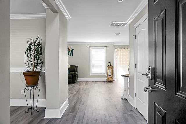 hall featuring wood-type flooring and ornamental molding