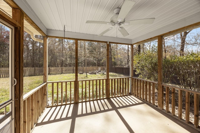 unfurnished sunroom with ceiling fan