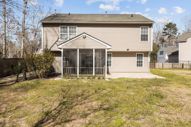 rear view of house with a yard, a patio area, a fenced backyard, and a sunroom