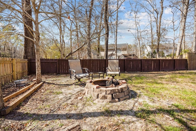 view of yard featuring an outdoor fire pit and a fenced backyard