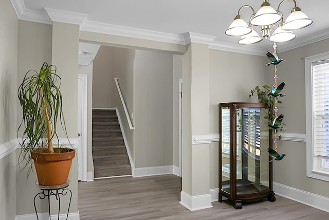 stairs with baseboards, wood finished floors, and crown molding