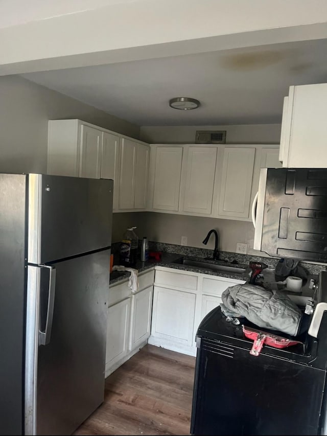 2053 Marsia Ln Unit A, B, C, D, North Charleston, SC 29405 - kitchen with freestanding refrigerator, range, white cabinets, and dark wood-type flooring