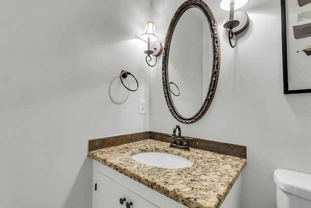 bathroom featuring toilet and vanity