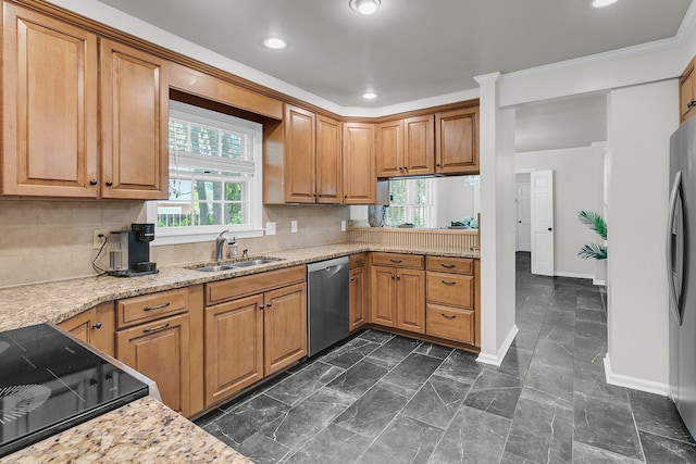 kitchen featuring a sink, baseboards, backsplash, and stainless steel appliances