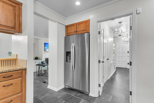 kitchen featuring crown molding, an inviting chandelier, brown cabinets, stainless steel fridge with ice dispenser, and light stone counters