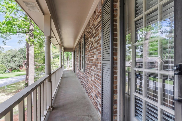 balcony featuring visible vents and covered porch