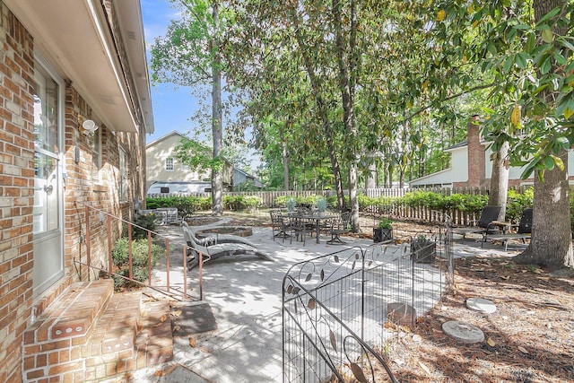 view of patio featuring fence and outdoor dining space
