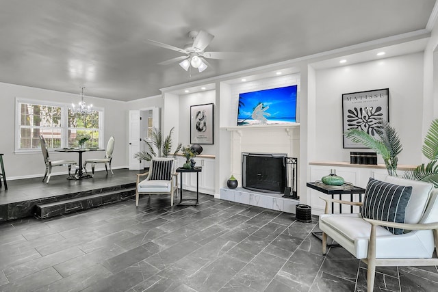 living area featuring recessed lighting, baseboards, ceiling fan with notable chandelier, and a tile fireplace