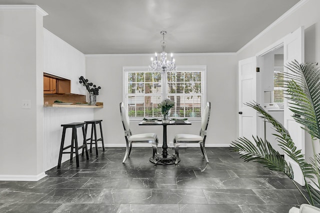 dining space featuring crown molding, baseboards, and a chandelier