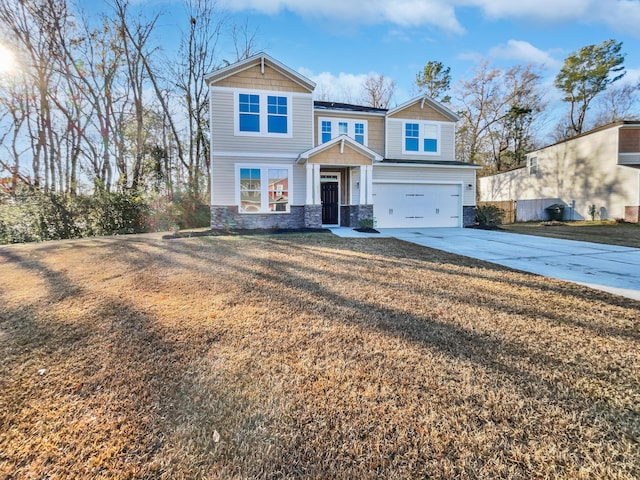 view of front of property with a front yard and a garage