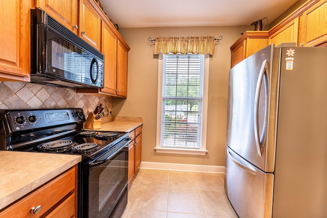 202 Trillium Ct, Santee, SC 29142 - kitchen featuring black appliances, decorative backsplash, baseboards, and light countertops