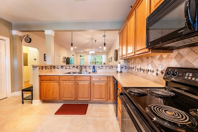 202 Trillium Ct, Santee, SC 29142 - kitchen with black appliances, a peninsula, brown cabinetry, and light countertops