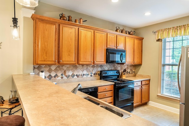 202 Trillium Ct, Santee, SC 29142 - kitchen featuring black appliances, tasteful backsplash, light tile patterned floors, light countertops, and a kitchen bar