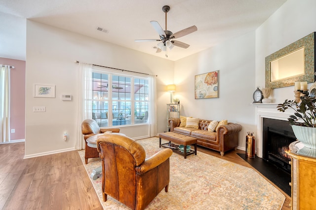 422 Cabrill Dr, Charleston, SC 29414 - living area featuring wood finished floors, ceiling fan, a fireplace with flush hearth, and baseboards