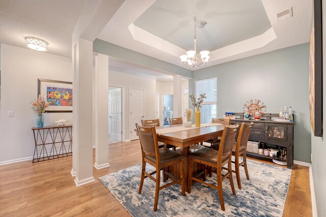 422 Cabrill Dr, Charleston, SC 29414 - dining area featuring a chandelier, wood finished floors, baseboards, a raised ceiling, and a textured ceiling