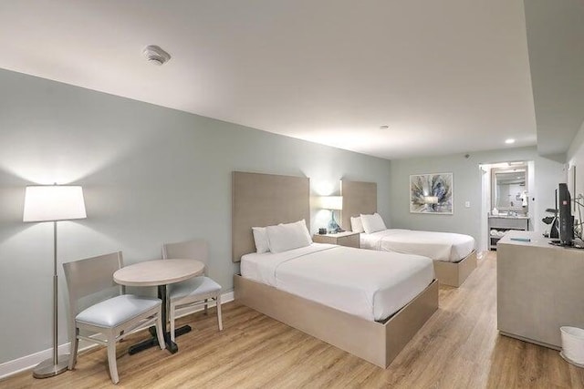 bedroom featuring light wood-type flooring and baseboards