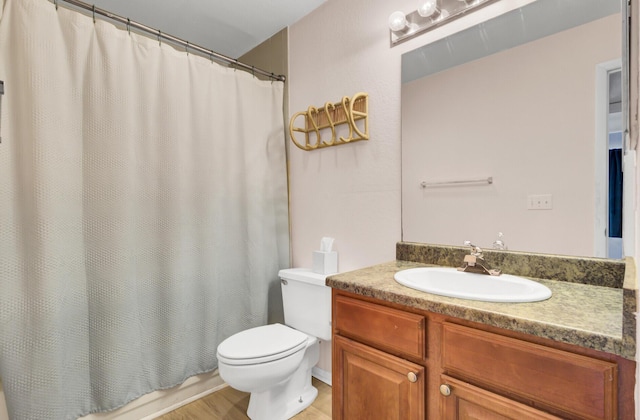 full bathroom featuring toilet and vanity