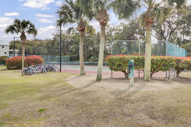 view of sport court featuring a yard and fence