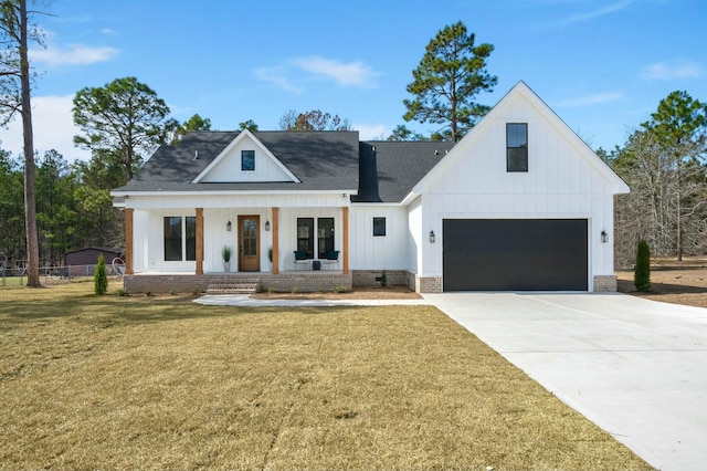 modern farmhouse style home with covered porch, concrete driveway, crawl space, board and batten siding, and a front yard