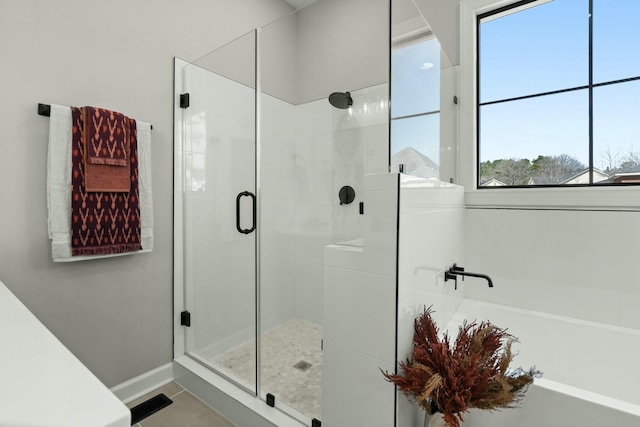 bathroom with a stall shower, visible vents, baseboards, tile patterned floors, and a bath