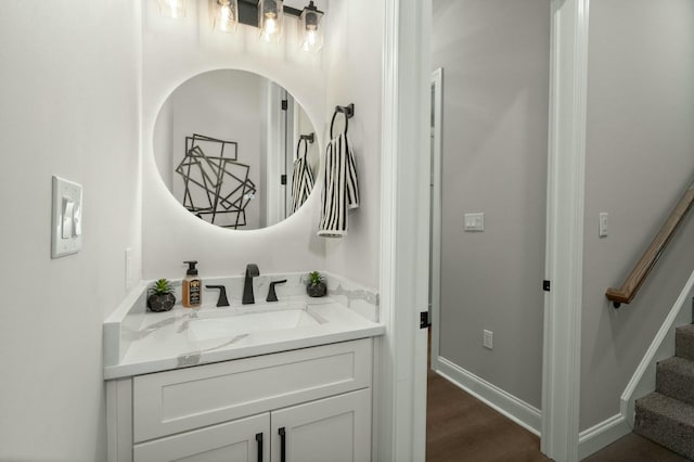 bathroom with vanity, baseboards, and wood finished floors