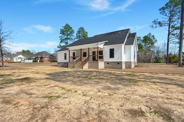 view of front of home with crawl space and a porch