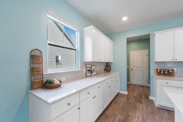 kitchen featuring white cabinets, dark hardwood / wood-style floors, and decorative backsplash