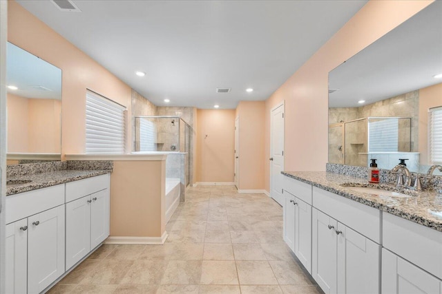 bathroom featuring tile patterned flooring, vanity, and shower with separate bathtub