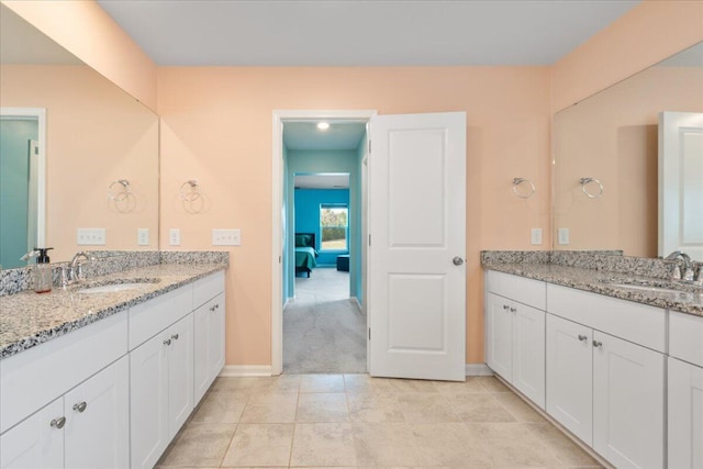 bathroom featuring tile patterned flooring and vanity