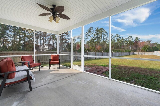 sunroom / solarium featuring ceiling fan