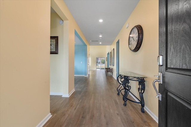 hall with hardwood / wood-style flooring