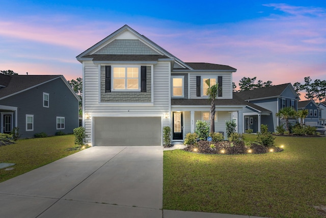 view of front of property with a garage and a lawn